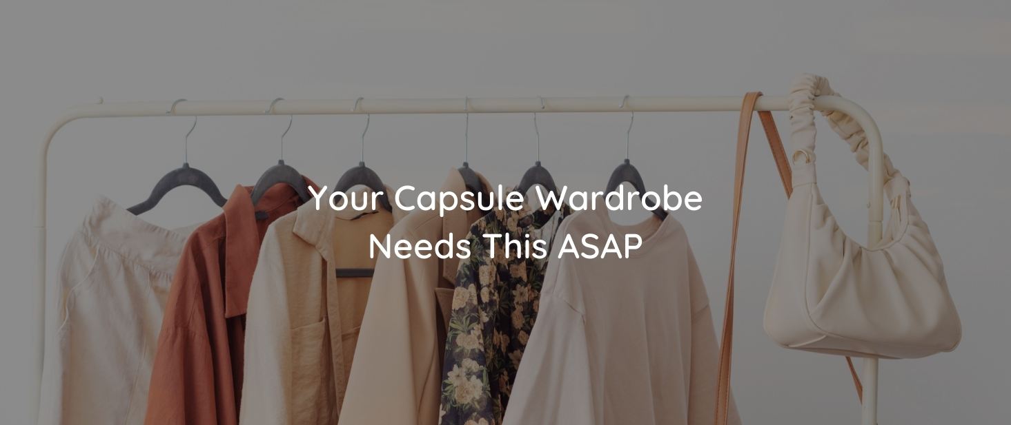 A clothing rack against a white wall. Clothing items and bags are hung on the rack. There is text on the image that reads “You Capsule Wardrobe Needs This ASAP”