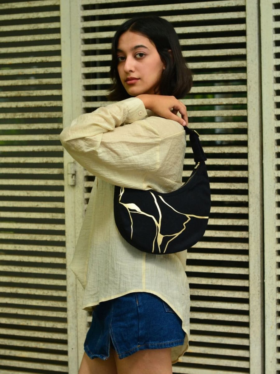 Kintsugi moon bag with artistic design worn as a shoulder bag