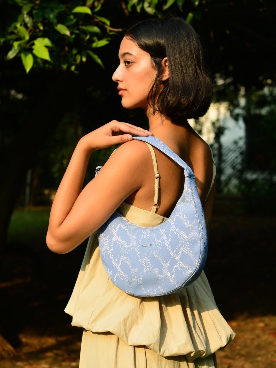 Siren moon bag with curved design worn as a shoulder bag