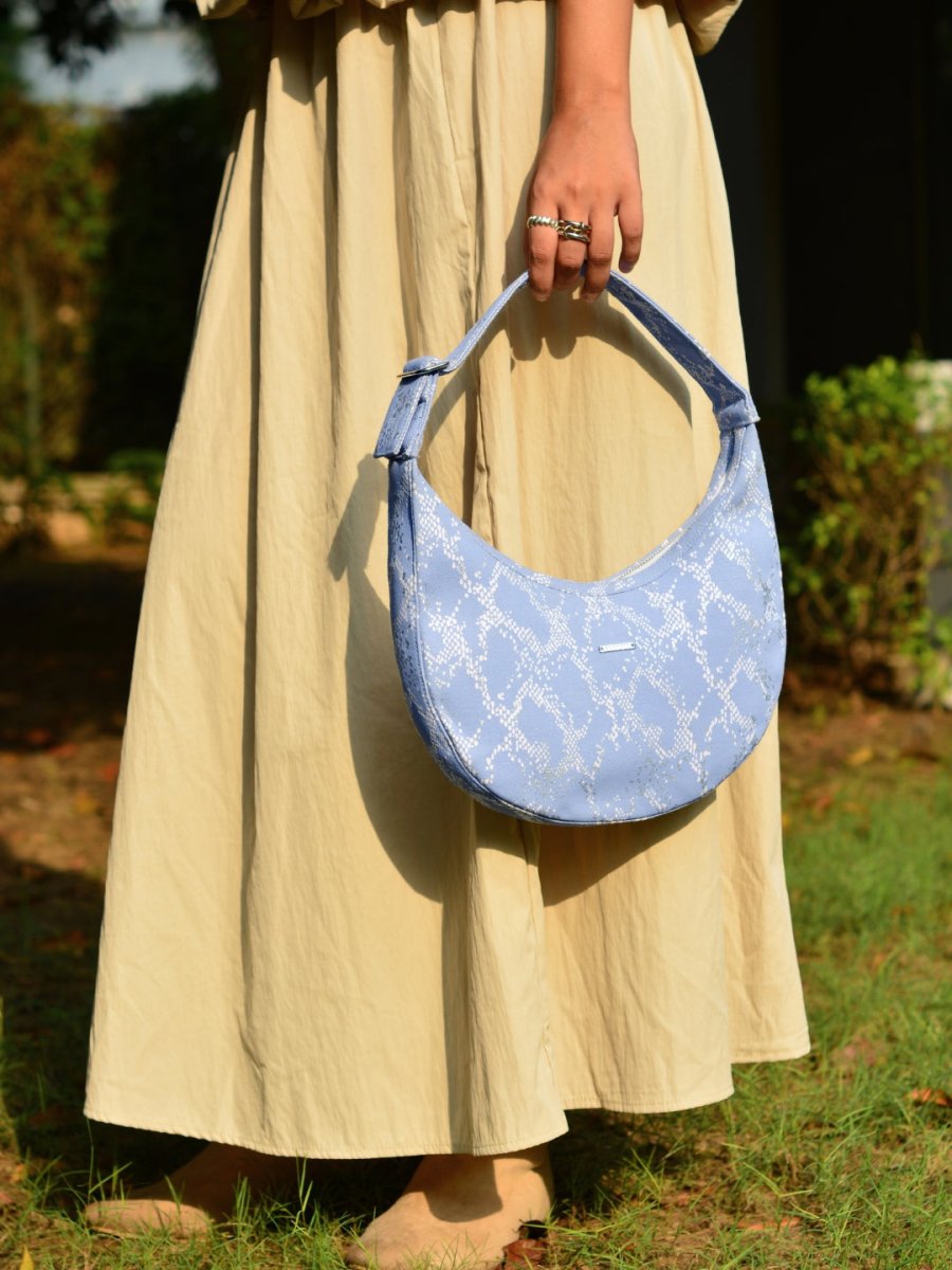 Siren moon bag with curved design worn as a shoulder bag
