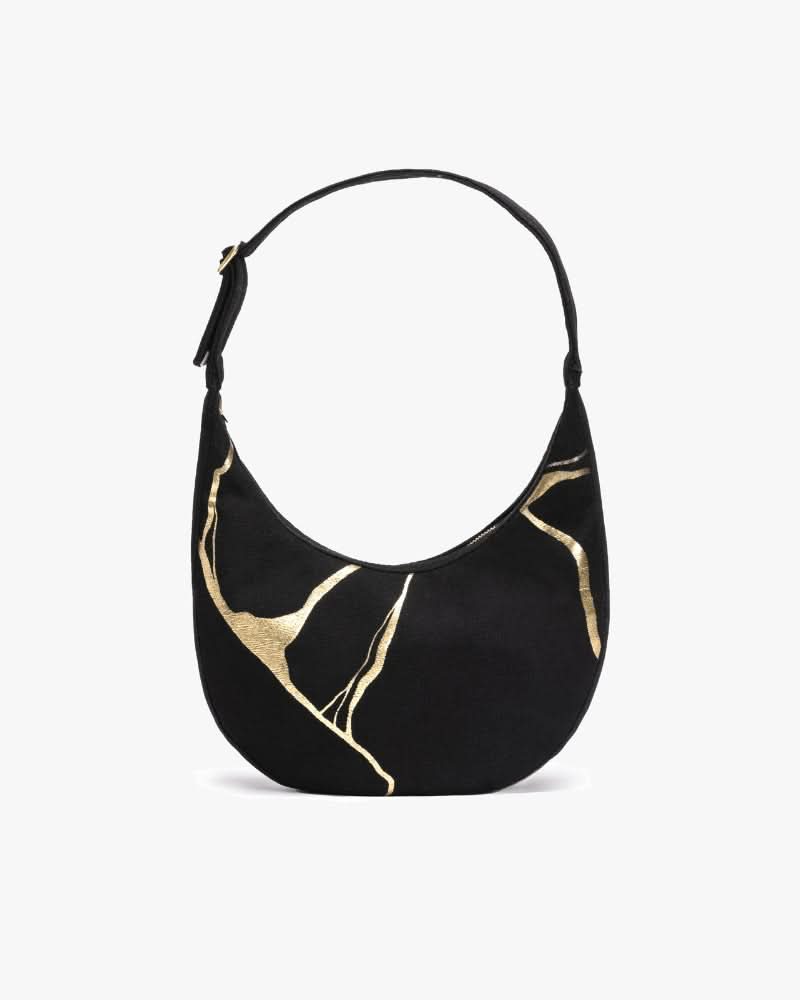 Kintsugi moon bag with artistic design worn as a shoulder bag
