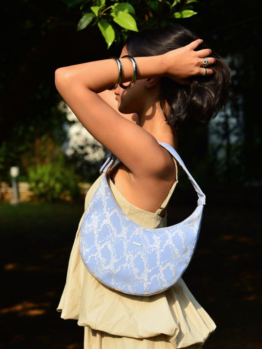 Siren moon bag with curved design worn as a shoulder bag
