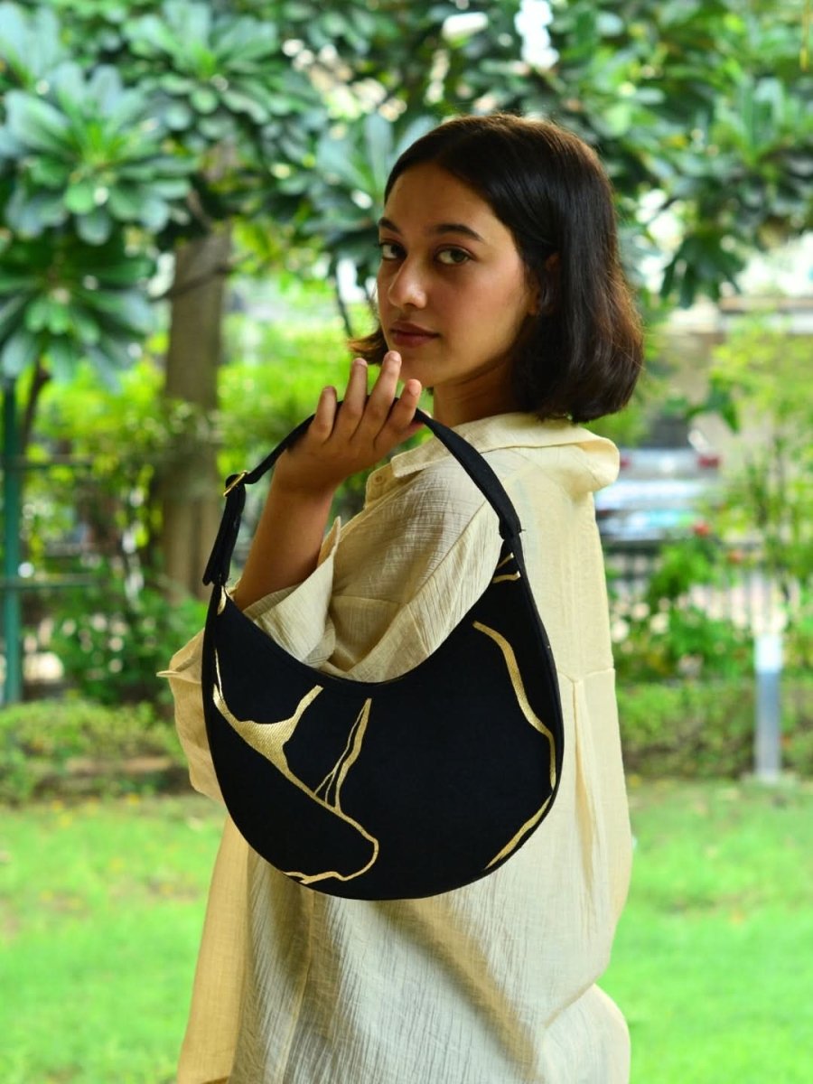Kintsugi moon bag with artistic design worn as a shoulder bag
