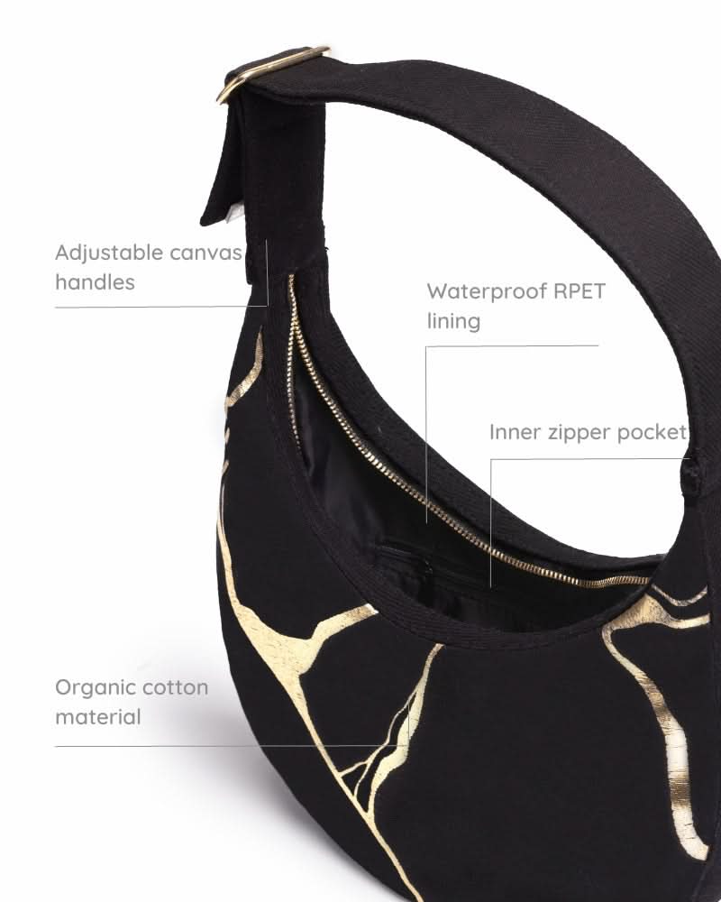Kintsugi moon bag with artistic design worn as a shoulder bag

